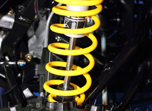Yellow suspension coil fitted to vehicle